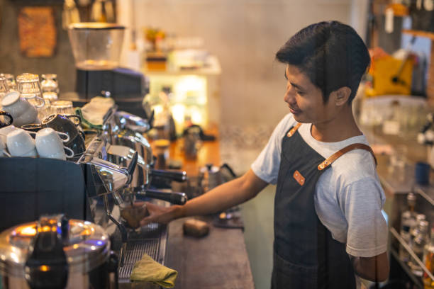smiling male barista preparing espresso coffee in coffee shop - bali male beautiful ethnicity imagens e fotografias de stock