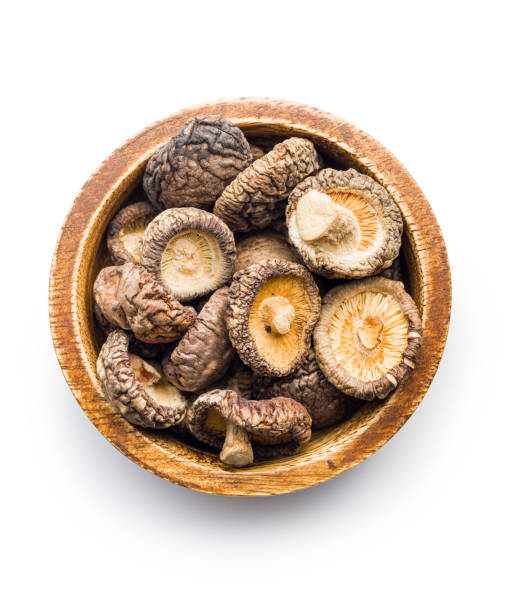 istock Dried shiitake mushrooms in bowl isolated on white background. 1479625250