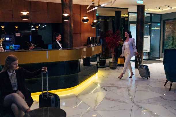 istock A smiling receptionist in uniform welcomes hotel guests at the reception 1479625691