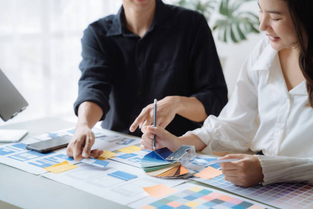 istock ui designer brainstorming about mobile app interface wireframe design with customer breif and color code at office. 1479628187