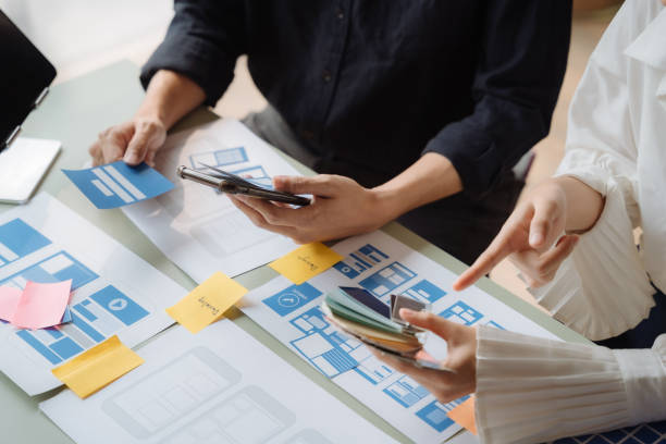 istock ui designer brainstorming about mobile app interface wireframe design with customer breif and color code at office. 1479628199