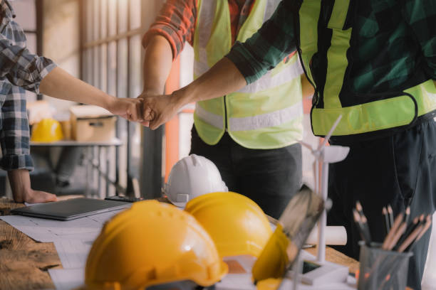 istock Team architects workers, men and women, join hands to join forces to join forces to work for the industry for success. Teamwork and professional colleagues : Workers' hands, teamwork concept. 1479634742