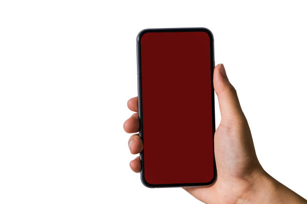Hand holding white mobile phone with blank red screen in white background.