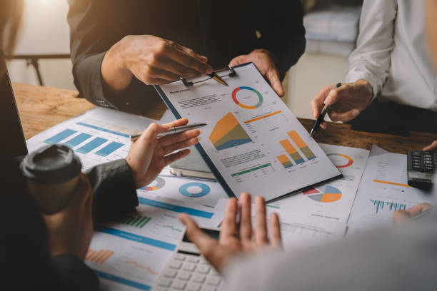 istock Teamwork process, Business team using a calculator to calculate the numbers of statistic business profits growth rate on documents graph data, desk in the office. 1479634808