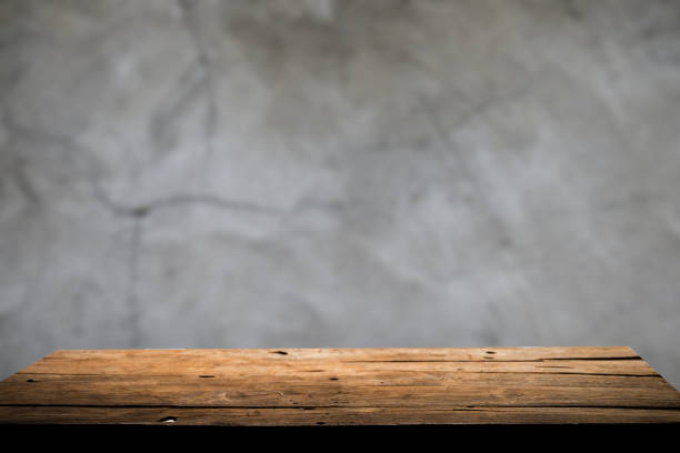 istock Empty wooden board on table top and blur inside over stucco wall blur background, mock up for display of goods. 1479634823