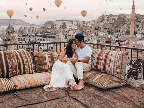 They have fun traveling together, romantic couple. They enjoy the view from a terrace