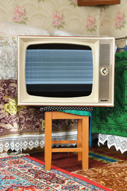 istock An old vintage TV with interference and noise on the screen in a rustic interior. 1479637816