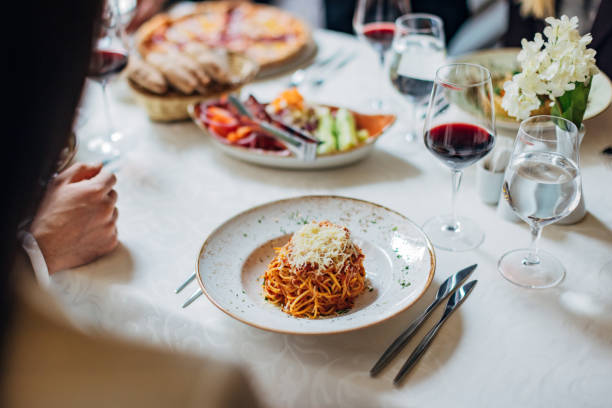 istock An unrecognizable woman is eating spaghetti in a restaurant 1479640096
