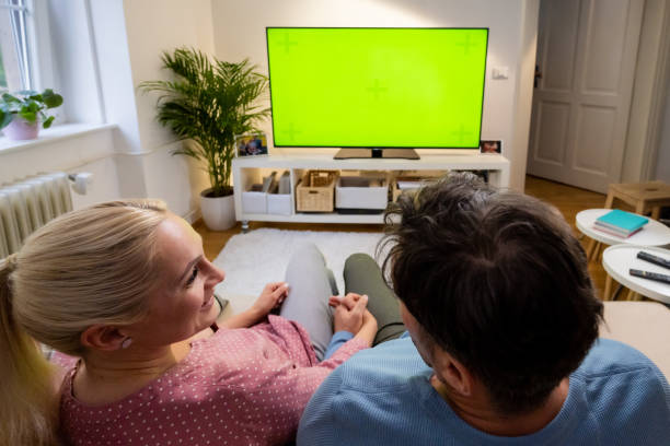 istock Couple holding hands and watching tv 1479641633