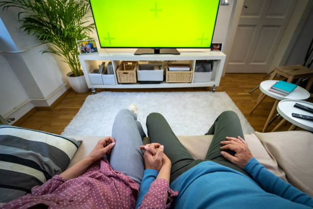 istock Couple holding hands and watching tv 1479641647