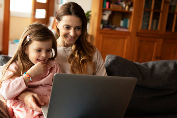 istock Beautiful girl watching cartoon with mom 1479642993