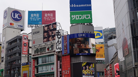 The Shibuya crossing in Tokyo, Japan is known for its famous giant LED screens and billboards that light up the cityscape. One of the most iconic billboards in Shibuya is the massive 3D curved screen above the Shibuya crossing, which is known as the \