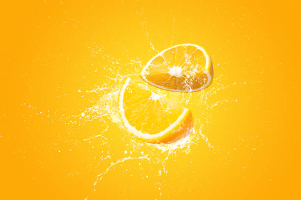 istock Creative layout made from Fresh Sliced oranges and Orange fruit and water Splashing on a orange background. 1479645543