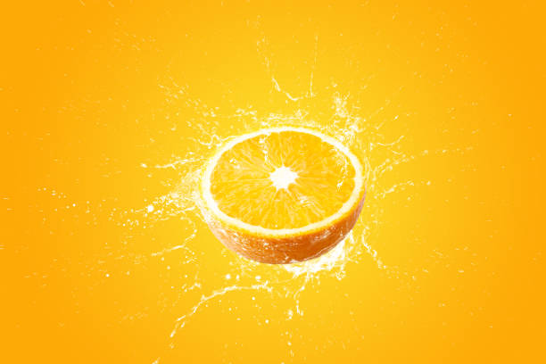 istock Creative layout made from Fresh Sliced oranges and Orange fruit and water Splashing on a orange background. 1479645550