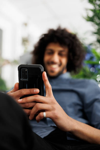 istock Smiling business employee browsing social network on mobile phone 1479646886