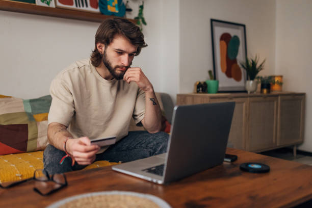 istock A man tries to make an online purchase using a laptop and credit card, but notices a problem 1479648043