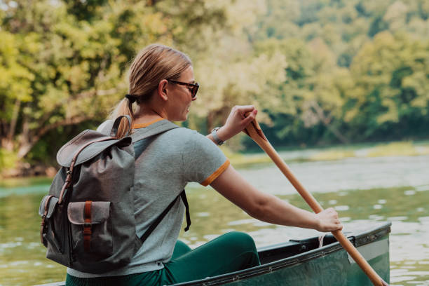 istock Woman adventurous explorer are canoeing in a wild river 1479652035
