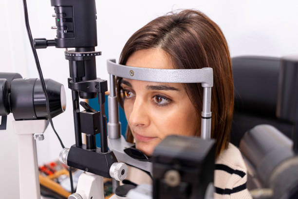 istock Young girl checking her eyesight in an optician's shop 1479662331