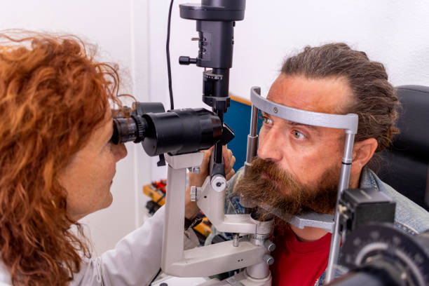 istock Red-haired optical doctor checks her hypster patient's eyesight 1479662347