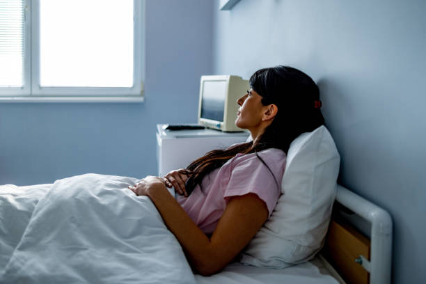 istock Hospitalized patient lying in bed looking away 1479665783