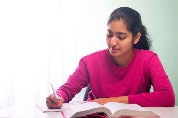 istock young teenager girl writing a notebook 1479666044
