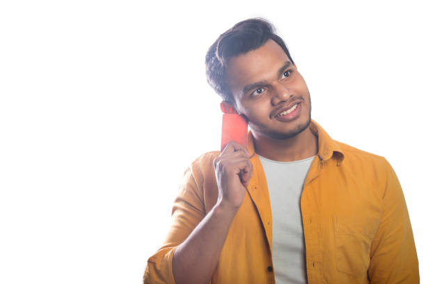 smiling young man holding a credit card