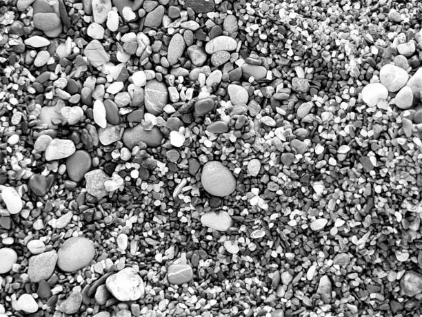 istock black and white texture of small stones of a beach 1479676552