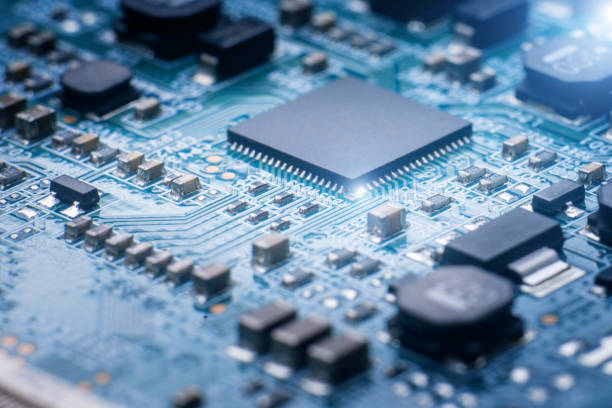 primo piano astratto sul microchip su circuito stampato blu - service electronics industry circuit board capacitor foto e immagini stock