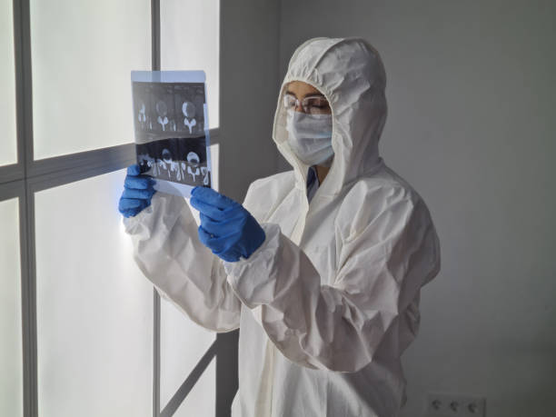 istock Doctor in protective suit and mask is holding an X-ray 1479685820