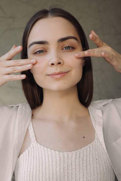 istock Female applying eye cream during skin care routine 1479685895