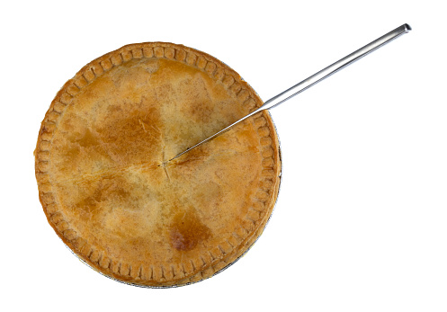 Overhead view of a chicken meat pie with a knife in the pie cutting it isolated on a white background.