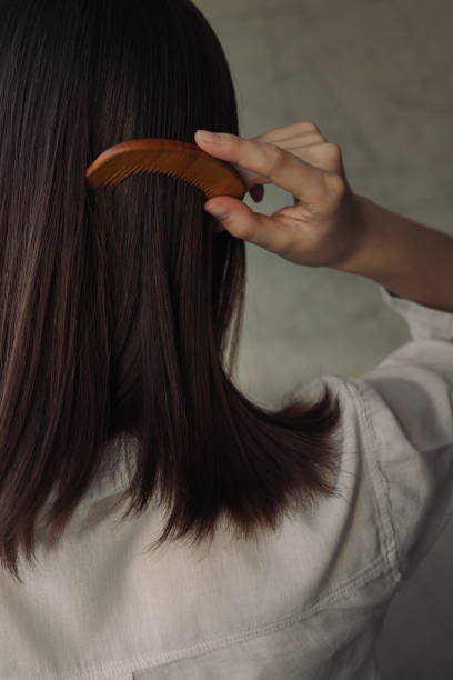 istock Woman brushing hair with comb at home 1479686069