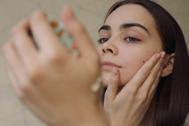 istock Closeup of woman doing beauty routine and applying moisturizer 1479686085