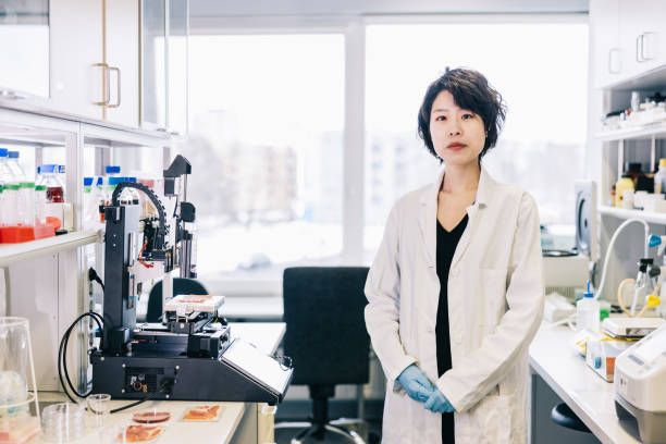 istock Female Japanese scientist stands alone in a laboratory 1479686848