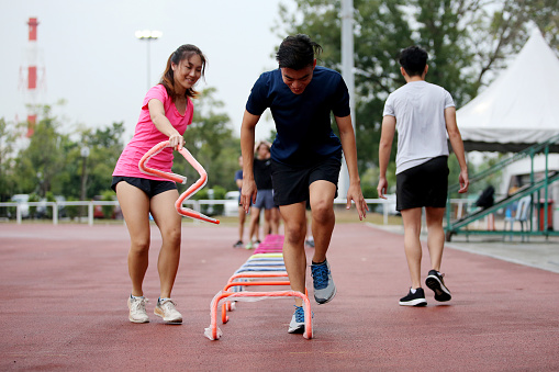 Asian young adults are arranging low bars for routine athletic training in stadium