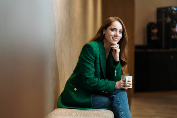istock Female financial advisor holding mug and smiling 1479689339