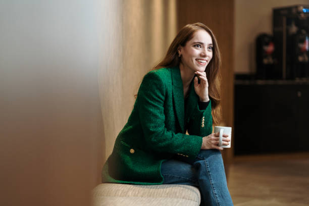 istock Friendly financial advisor sitting in coworking space with mug 1479689463