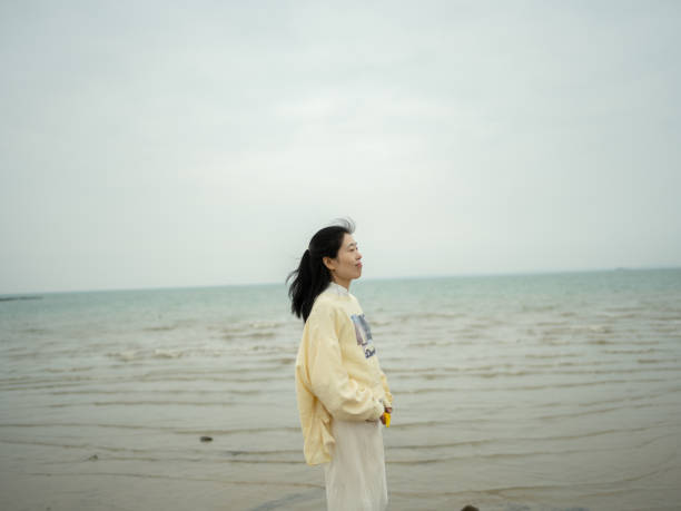 istock woman standing by the sea 1479691137