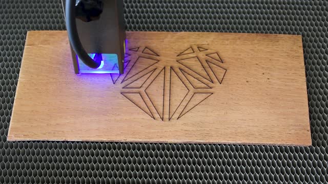 Diode laser engraving and cutting a polygonal heart model on wood