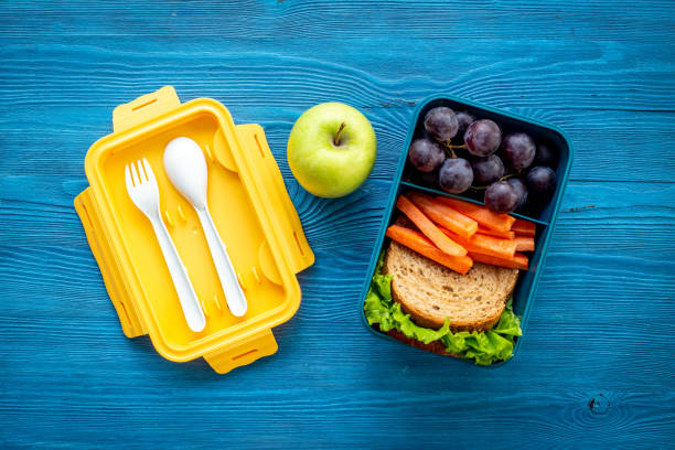 istock School lunchbox with fruits and sandwich, top view 1479693686