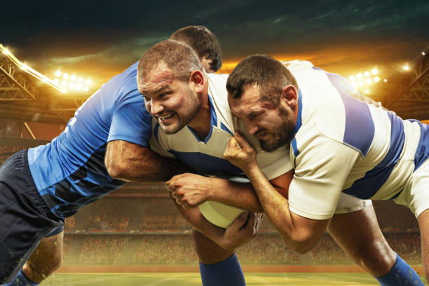 Tense moment. Three men, professional rugby player in motions,. competing at open air 3D stadium in evening. Championship Tense moment. Three men, professional rugby player in motions,. competing at open air 3D stadium in evening. Championship. Concept of match, sport, competition, action and motion, game, cup. Touchdown stock pictures, royalty-free photos & images