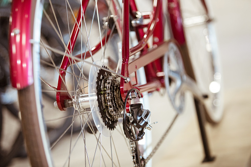 Red bike and close up of bicycle derailleurs gear.