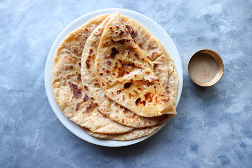 Puran Poli is an Indian sweet flatbread stuffed with chana dal, jaggery, ghee and cardamom and is usually eaten at Holi or Gudi Padva festival. Recipe ingredients. copy space. Healthy sweet dessert.