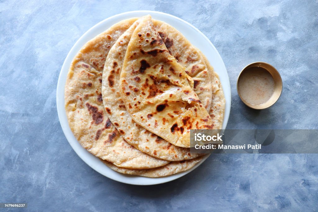 Puran Poli is an Indian sweet flatbread stuffed with chana dal, jaggery, ghee and cardamom and is usually eaten at Holi or Gudi Padva festival. Recipe ingredients. copy space. Healthy sweet dessert. Roti Stock Photo