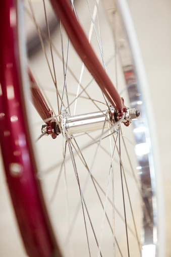 Close up of red bicycle wheel and fork