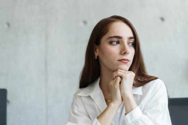 istock Pensive young businesswoman looking away 1479696676