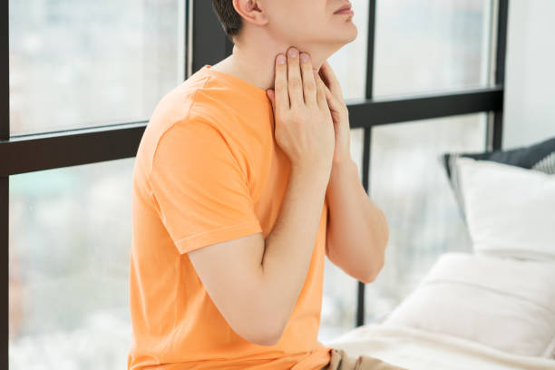 sore throat and cough, man with pain in neck at home - surprise color image gasping the human body imagens e fotografias de stock