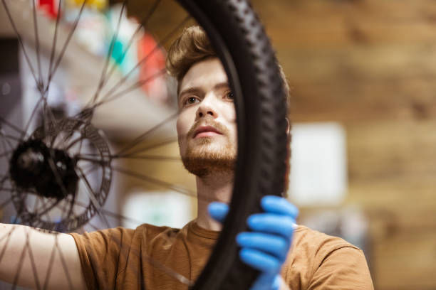 istock Serviceman repairing a tire on a bicycle 1479698640