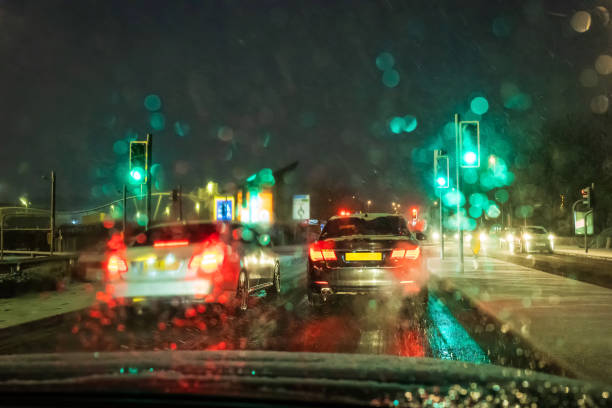 istock Moving road traffic while snowing at night in england uk 1479699626