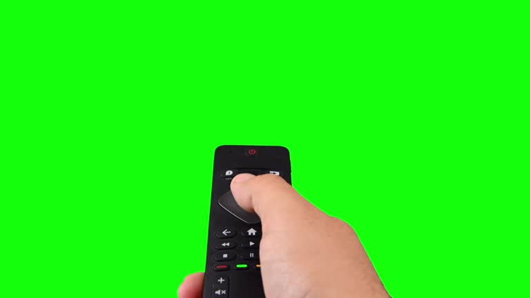 Hand zapping with tv remote control on chroma key green